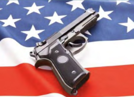 gun on top of an american flag