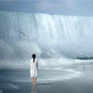 woman standing in front of waterfall
