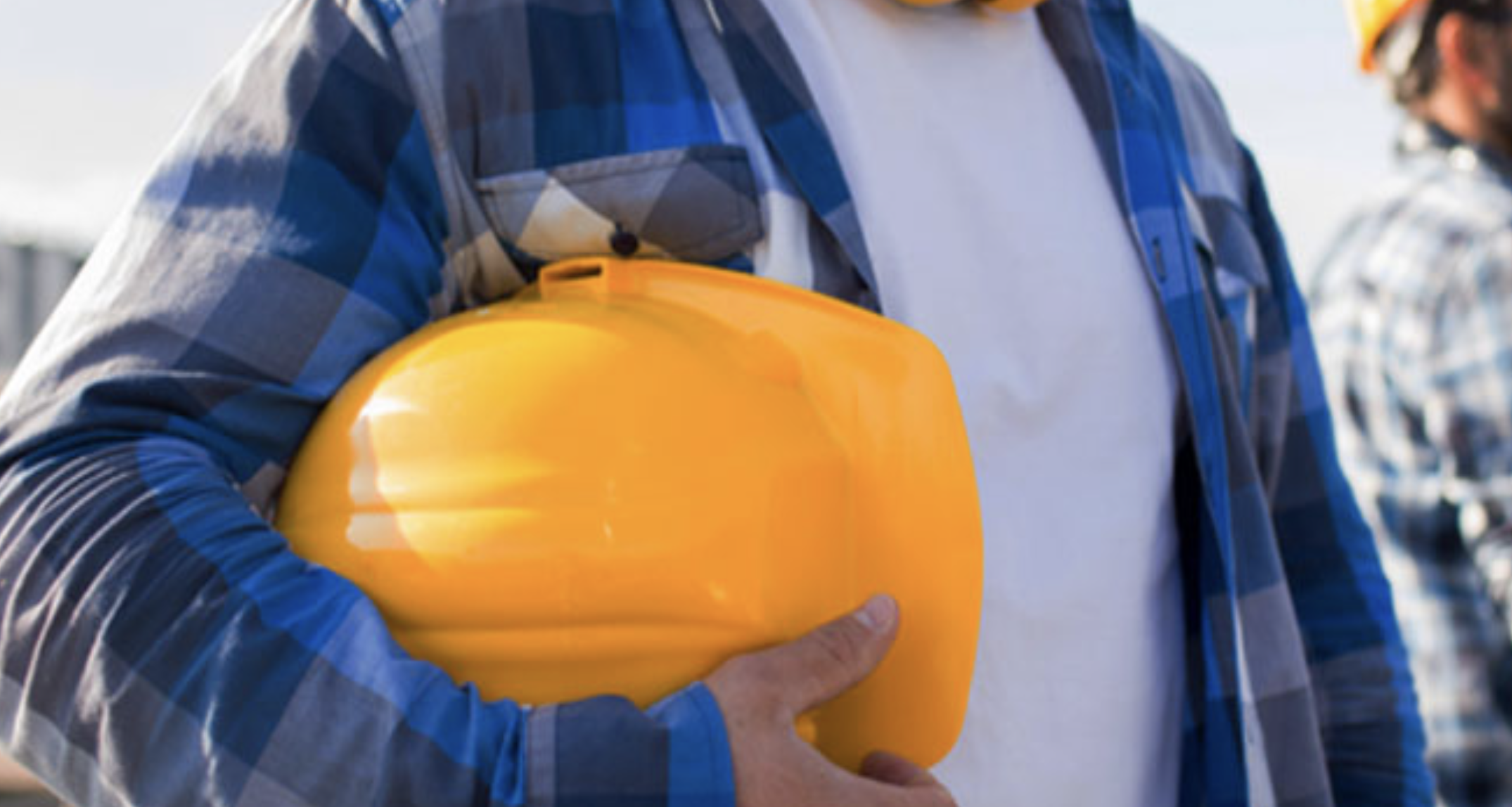 construction worker holding yellow hard hat