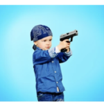 baby holding a gun