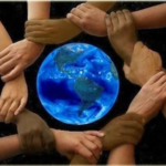 people holding hands around globe
