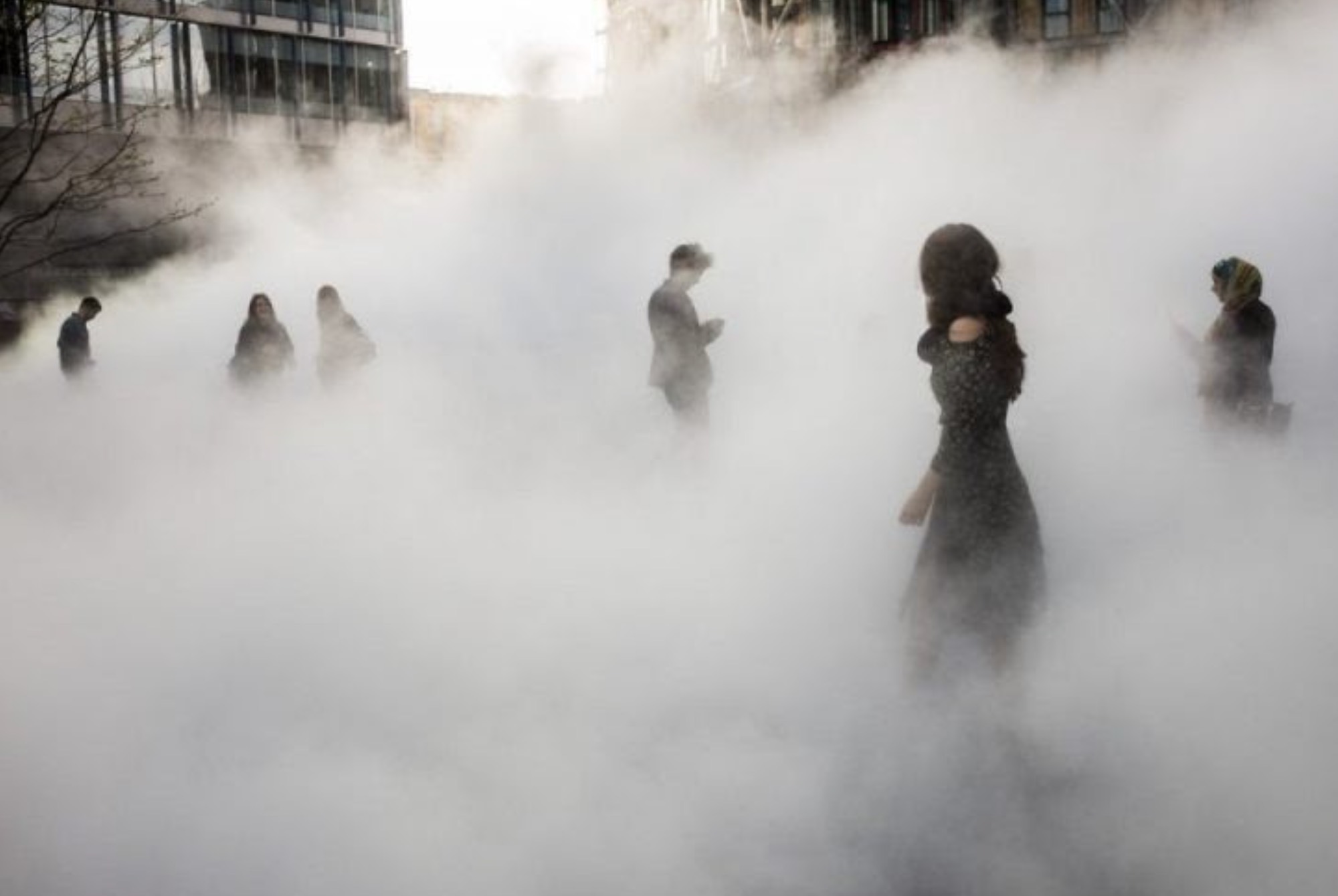 people walking through fog