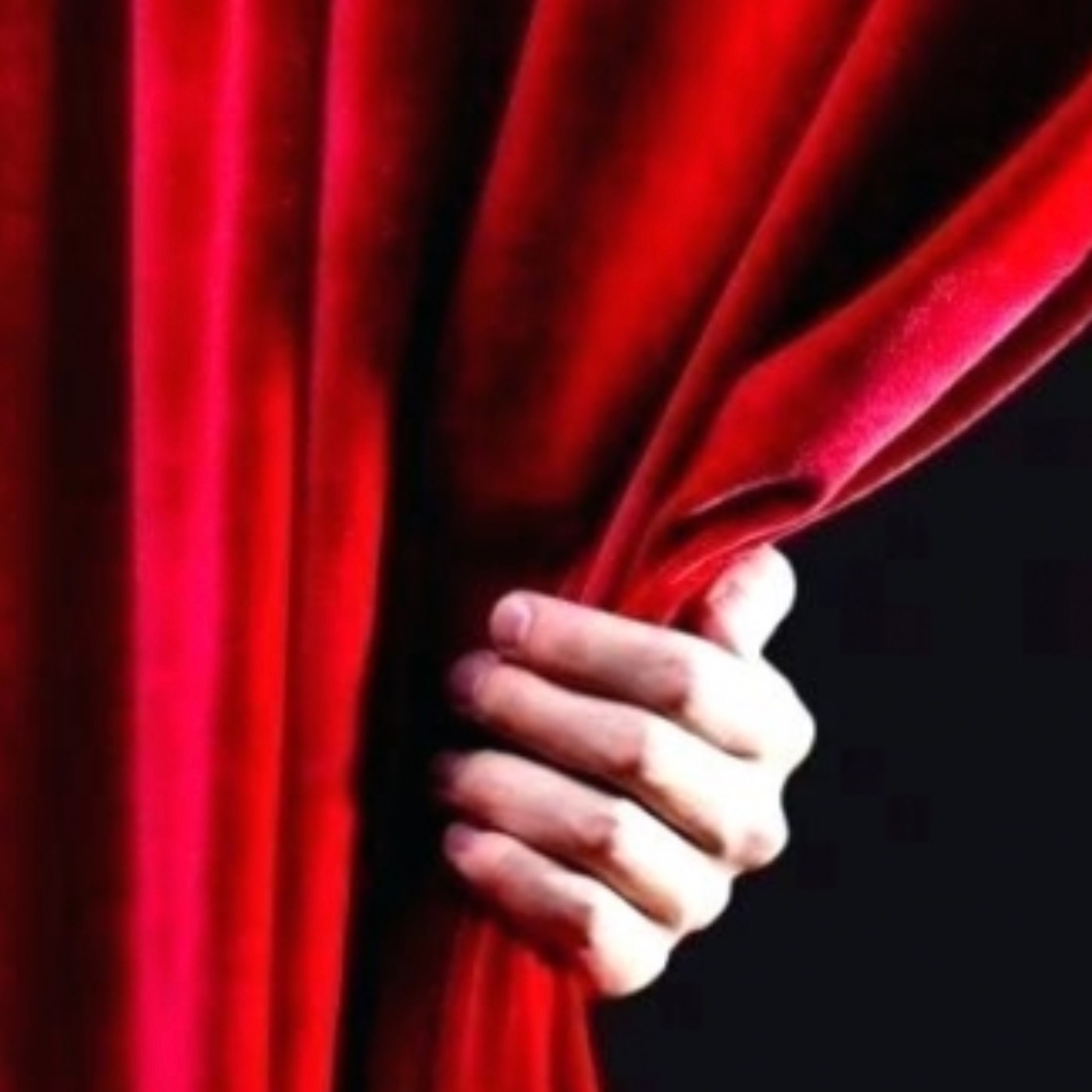 hand pulling back red curtain