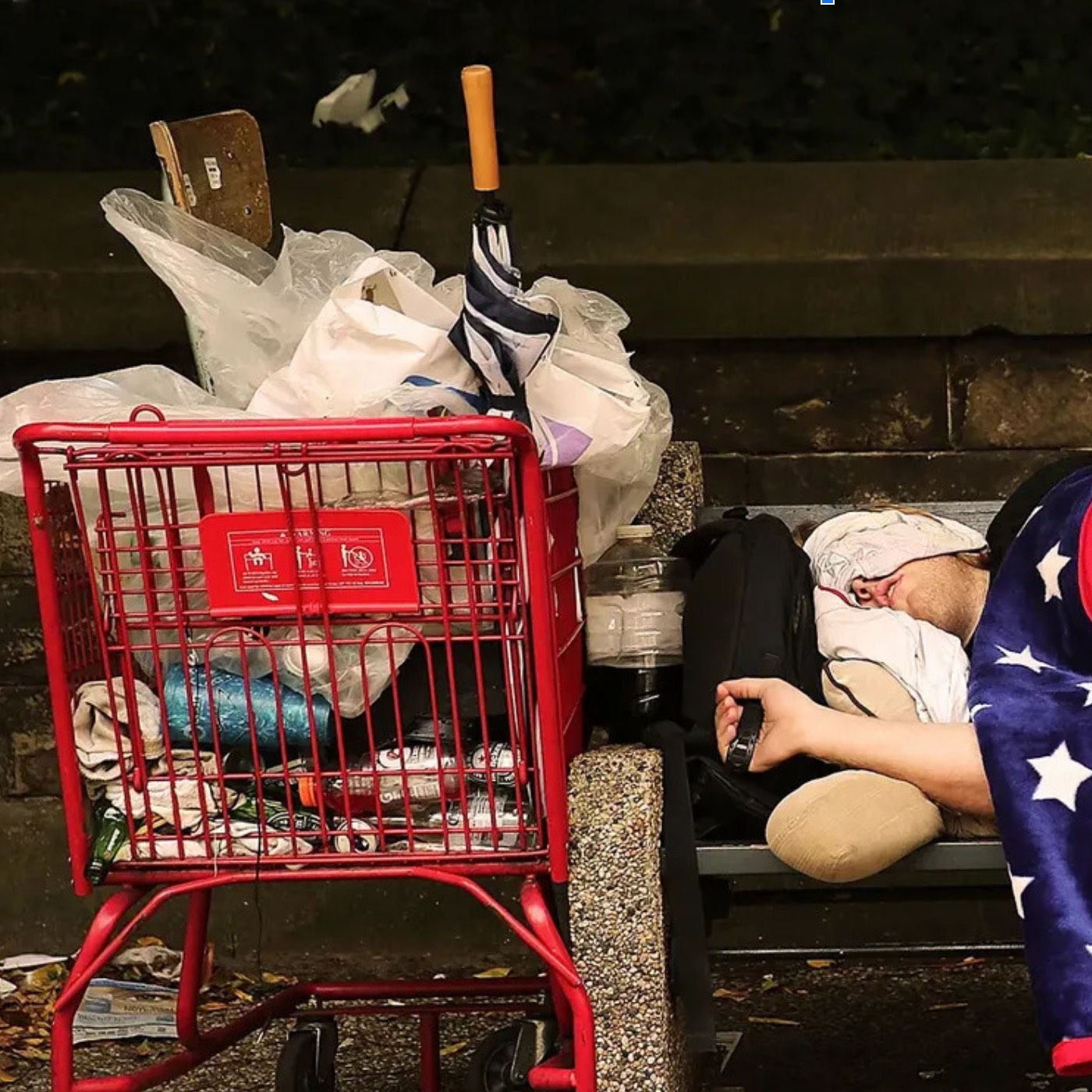 unhoused person with shopping cart